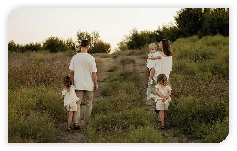A family walks up a hill.