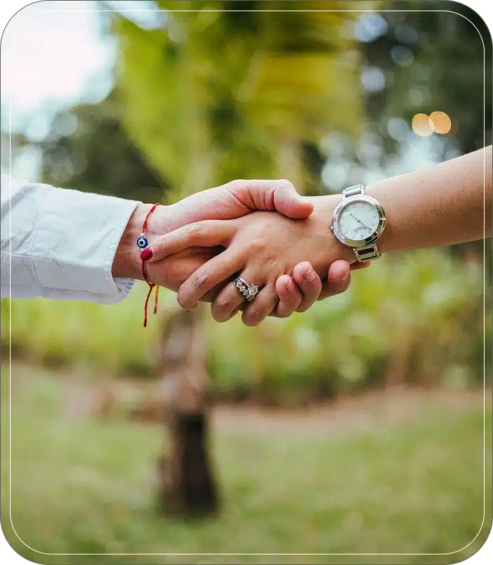 Two people shake hands.
